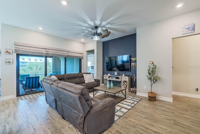 living room featuring wood finished floors, baseboards, recessed lighting, and a ceiling fan