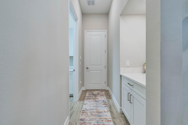 entryway with light wood-style flooring and baseboards