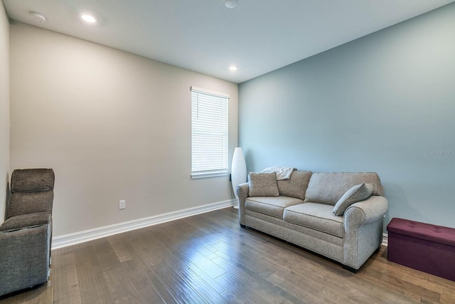living area with baseboards, dark wood-style floors, and recessed lighting