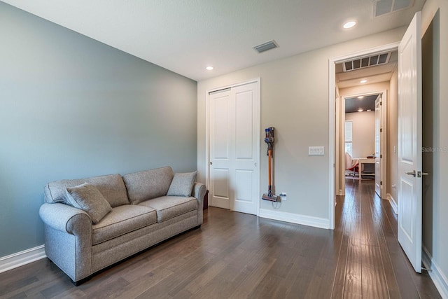 living area featuring dark wood-type flooring, baseboards, and recessed lighting