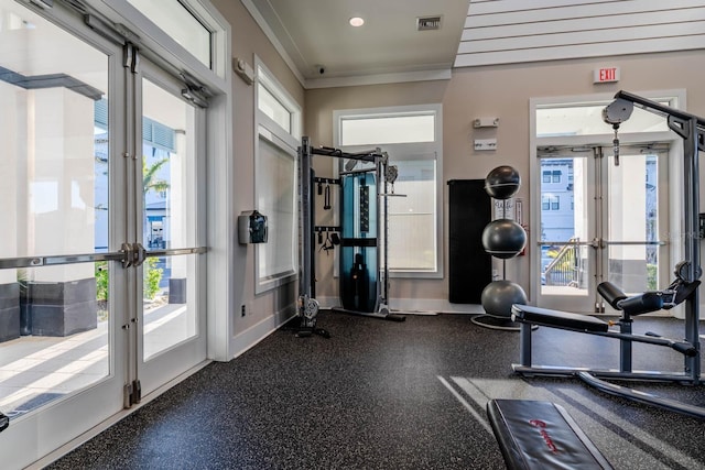 exercise room featuring french doors, healthy amount of natural light, crown molding, recessed lighting, and baseboards