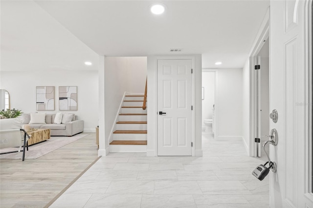 13934 Clubhouse Cir Unit 8, Tampa, FL 33618 - hall featuring stairs, recessed lighting, baseboards, and light marble finish flooring