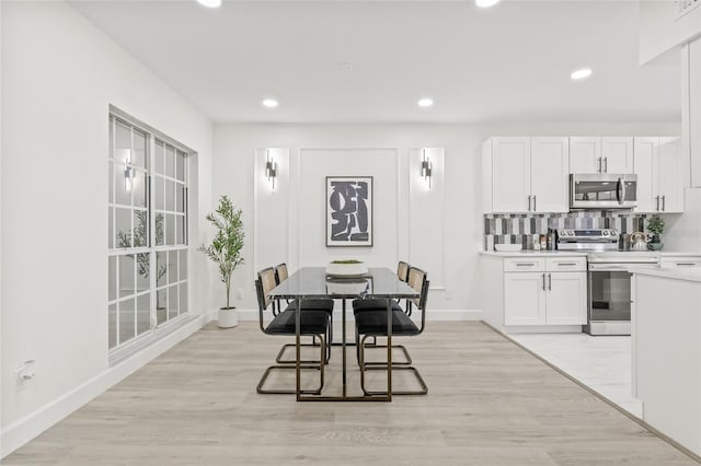 13934 Clubhouse Cir Unit 8, Tampa, FL 33618 - dining room featuring baseboards, light wood-type flooring, and recessed lighting