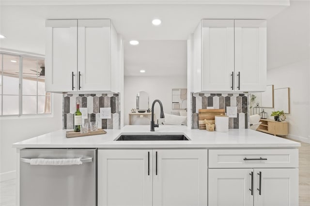 13934 Clubhouse Cir Unit 8, Tampa, FL 33618 - kitchen featuring stainless steel dishwasher, a sink, baseboards, white cabinets, and recessed lighting