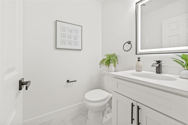 13934 Clubhouse Cir Unit 8, Tampa, FL 33618 - bathroom featuring vanity, toilet, marble finish flooring, and baseboards