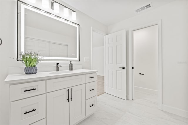 13934 Clubhouse Cir Unit 8, Tampa, FL 33618 - bathroom featuring vanity, baseboards, and marble finish flooring