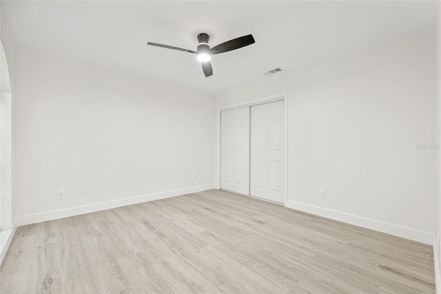 13934 Clubhouse Cir Unit 8, Tampa, FL 33618 - unfurnished bedroom featuring wood finished floors, baseboards, a closet, and ceiling fan