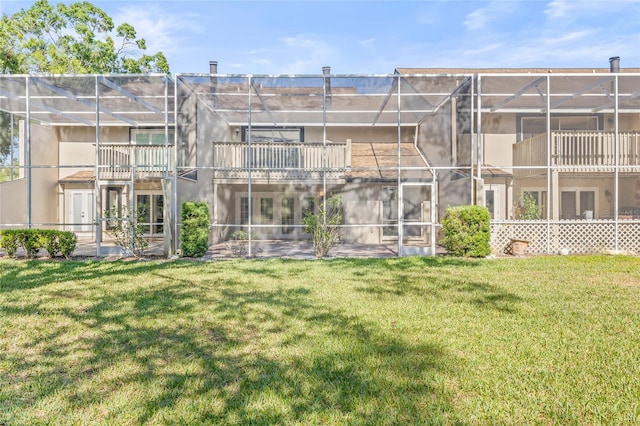 13934 Clubhouse Cir Unit 8, Tampa, FL 33618 - rear view of property with a yard, stucco siding, and glass enclosure