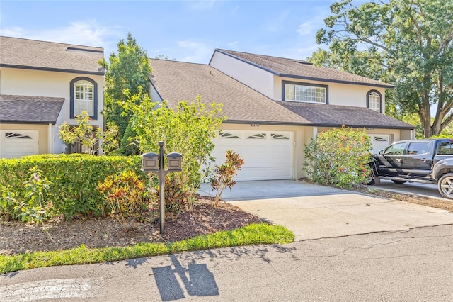 13934 Clubhouse Cir Unit 8, Tampa, FL 33618 - traditional home with stucco siding, a garage, concrete driveway, and a shingled roof