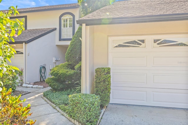13934 Clubhouse Cir Unit 8, Tampa, FL 33618 - entrance to property featuring stucco siding, a garage, a shingled roof, and driveway