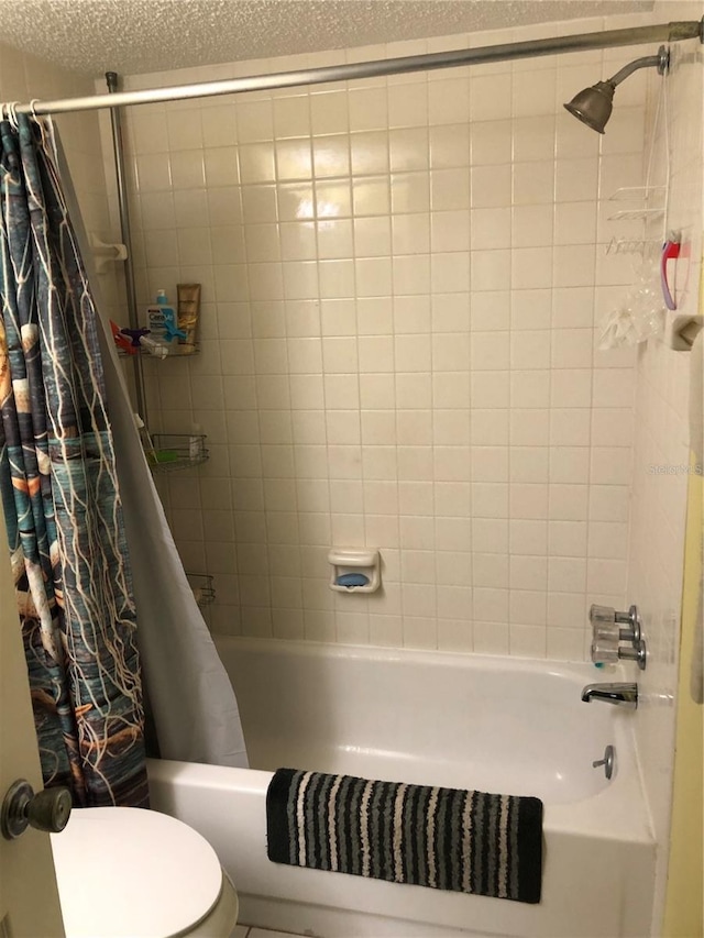860 Virginia St Unit 308, Dunedin, FL 34698 - full bath featuring shower / bathtub combination with curtain, toilet, and a textured ceiling