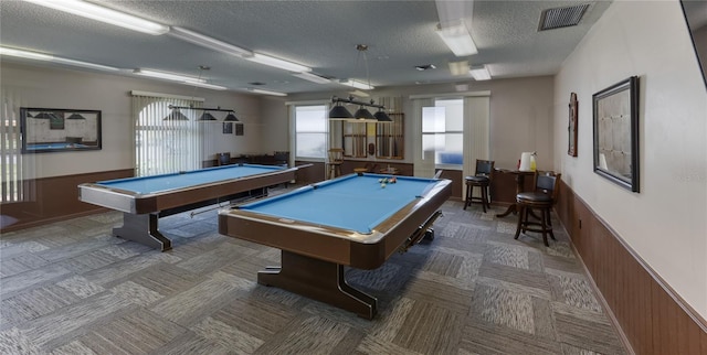 game room with a textured ceiling, carpet floors, pool table, and wainscoting