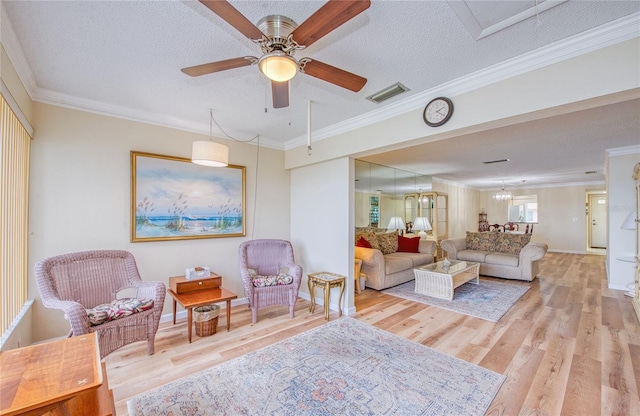 19029 US Highway 19 N Unit 31F, Clearwater, FL 33764 - living area featuring wood finished floors, a textured ceiling, crown molding, a ceiling fan, and baseboards