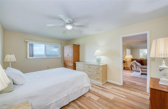 19029 US Highway 19 N Unit 31F, Clearwater, FL 33764 - bedroom with light wood finished floors, baseboards, and a ceiling fan