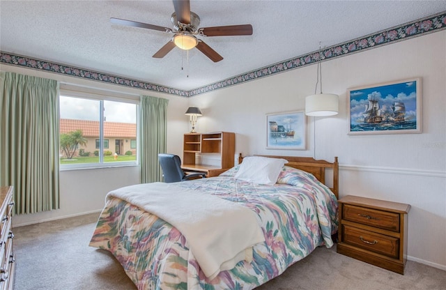 19029 US Highway 19 N Unit 31F, Clearwater, FL 33764 - bedroom with carpet flooring, a textured ceiling, baseboards, and a ceiling fan