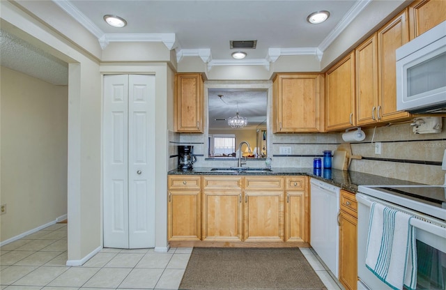19029 US Highway 19 N Unit 31F, Clearwater, FL 33764 - kitchen featuring white appliances, a sink, light tile patterned flooring, backsplash, and crown molding
