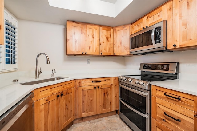 11440 Harbor Way Unit 5009, Largo, FL 33774 - kitchen with stainless steel appliances, a sink, light countertops, and light brown cabinetry