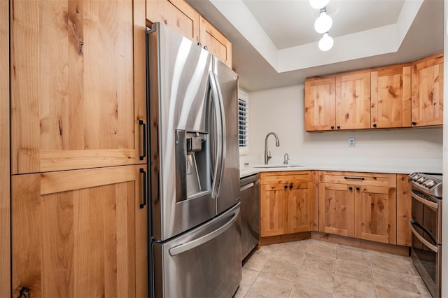 11440 Harbor Way Unit 5009, Largo, FL 33774 - kitchen with stainless steel appliances, a sink, a tray ceiling, and light countertops