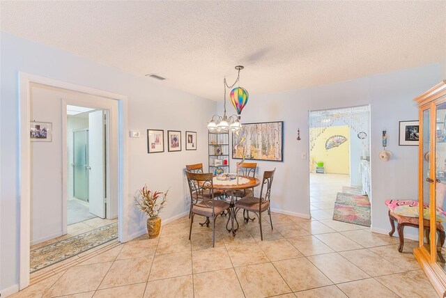 11200 102nd Ave Unit 75, Seminole, FL 33778 - dining area with light tile patterned floors, a chandelier, and a textured ceiling