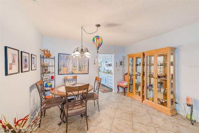 11200 102nd Ave Unit 75, Seminole, FL 33778 - dining room featuring a chandelier, a textured ceiling, and light tile patterned floors