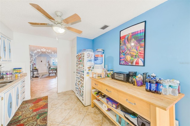11200 102nd Ave Unit 75, Seminole, FL 33778 - hall featuring light tile patterned floors, a sink, and a textured ceiling