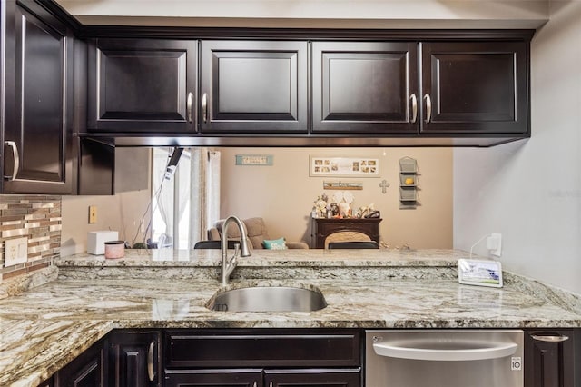 2816 Manor Hill Dr, Brandon, FL 33511 - kitchen with stainless steel dishwasher, a sink, light stone counters, and tasteful backsplash