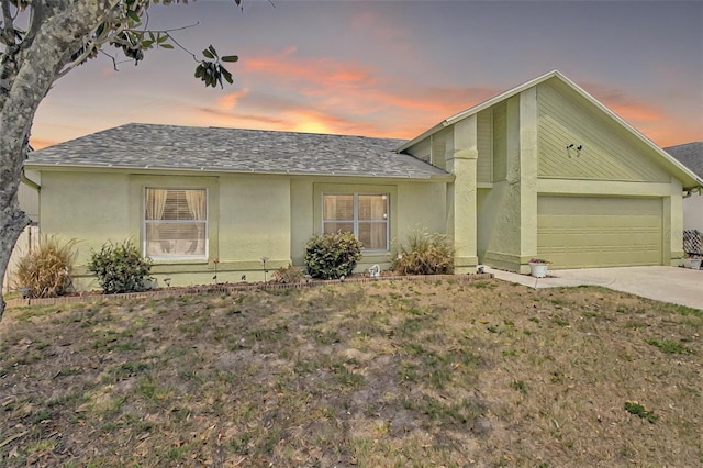 2816 Manor Hill Dr, Brandon, FL 33511 - view of front of home featuring an attached garage, a shingled roof, concrete driveway, and stucco siding