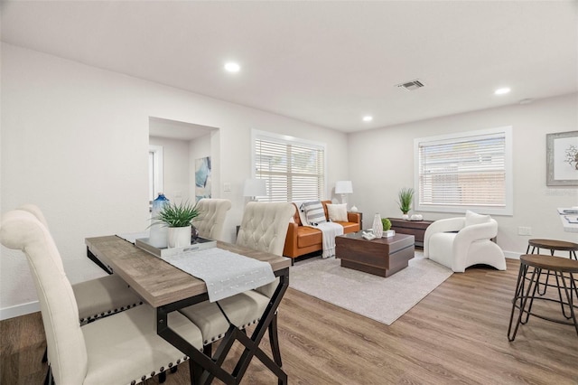 dining area featuring light wood finished floors, recessed lighting, and baseboards