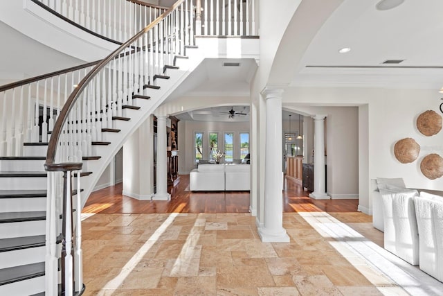 17129 Breeders Cup Dr, Odessa, FL 33556 - foyer entrance featuring decorative columns, stone tile floors, a ceiling fan, ornamental molding, and baseboards