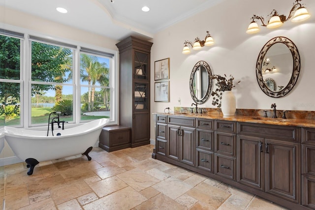 17129 Breeders Cup Dr, Odessa, FL 33556 - full bath with double vanity, stone tile flooring, a freestanding tub, ornamental molding, and recessed lighting