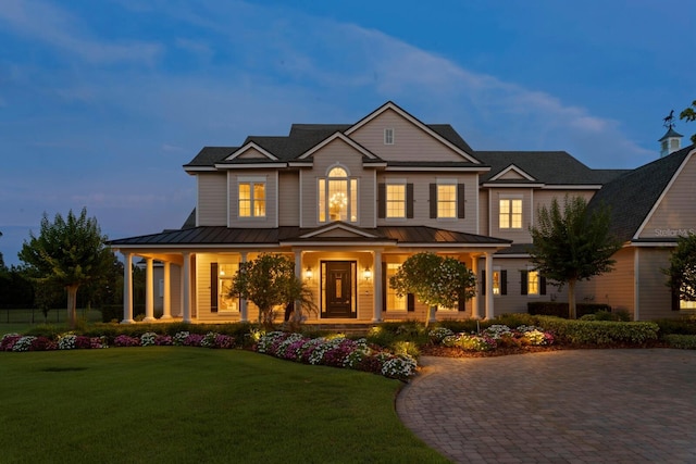 17129 Breeders Cup Dr, Odessa, FL 33556 - view of front facade with a porch, a standing seam roof, and metal roof