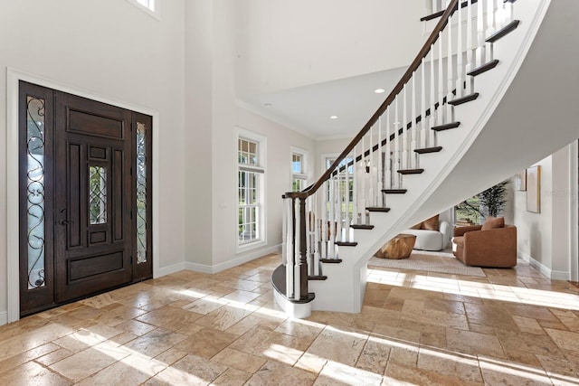 17129 Breeders Cup Dr, Odessa, FL 33556 - foyer entrance with stone tile floors, plenty of natural light, baseboards, a high ceiling, and crown molding