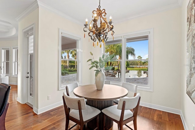 17129 Breeders Cup Dr, Odessa, FL 33556 - dining area featuring a chandelier, wood finished floors, a water view, crown molding, and baseboards