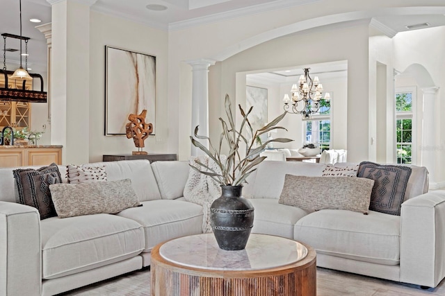 17129 Breeders Cup Dr, Odessa, FL 33556 - living area featuring crown molding, decorative columns, light wood-style flooring, a chandelier, and arched walkways
