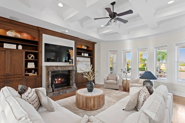 17129 Breeders Cup Dr, Odessa, FL 33556 - living room featuring light wood finished floors, coffered ceiling, a ceiling fan, a premium fireplace, and recessed lighting