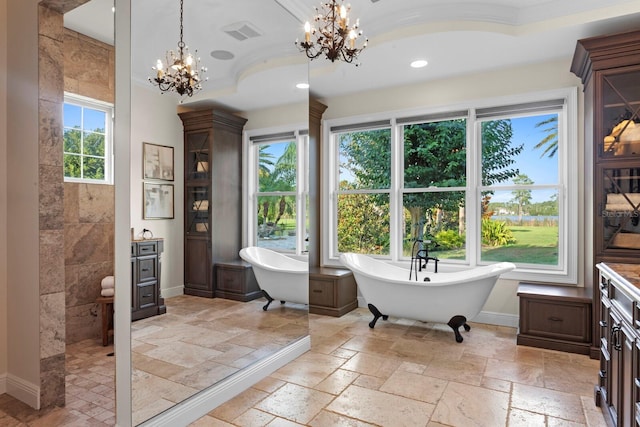 17129 Breeders Cup Dr, Odessa, FL 33556 - full bath featuring a chandelier, stone tile floors, a soaking tub, baseboards, and vanity