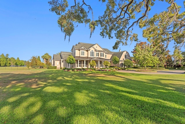 17129 Breeders Cup Dr, Odessa, FL 33556 - view of front of home featuring a front lawn, covered porch, a standing seam roof, and metal roof