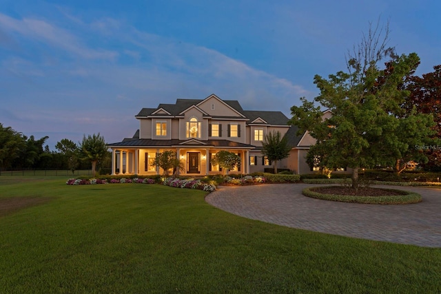 17129 Breeders Cup Dr, Odessa, FL 33556 - view of front of house featuring curved driveway, a porch, metal roof, and a standing seam roof