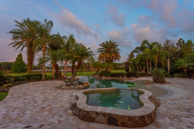17129 Breeders Cup Dr, Odessa, FL 33556 - pool at dusk with an in-ground hot tub