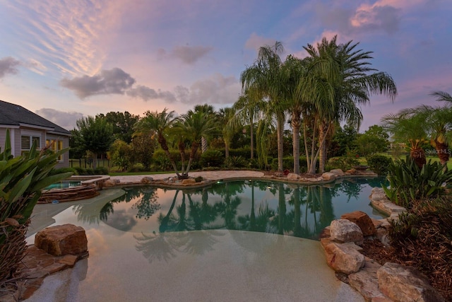17129 Breeders Cup Dr, Odessa, FL 33556 - pool at dusk featuring a pool with connected hot tub