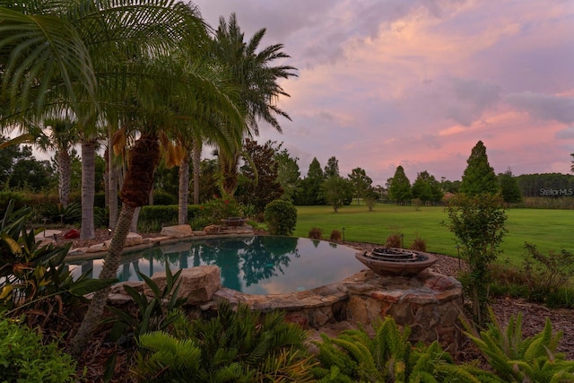 17129 Breeders Cup Dr, Odessa, FL 33556 - pool at dusk with an outdoor pool and a yard