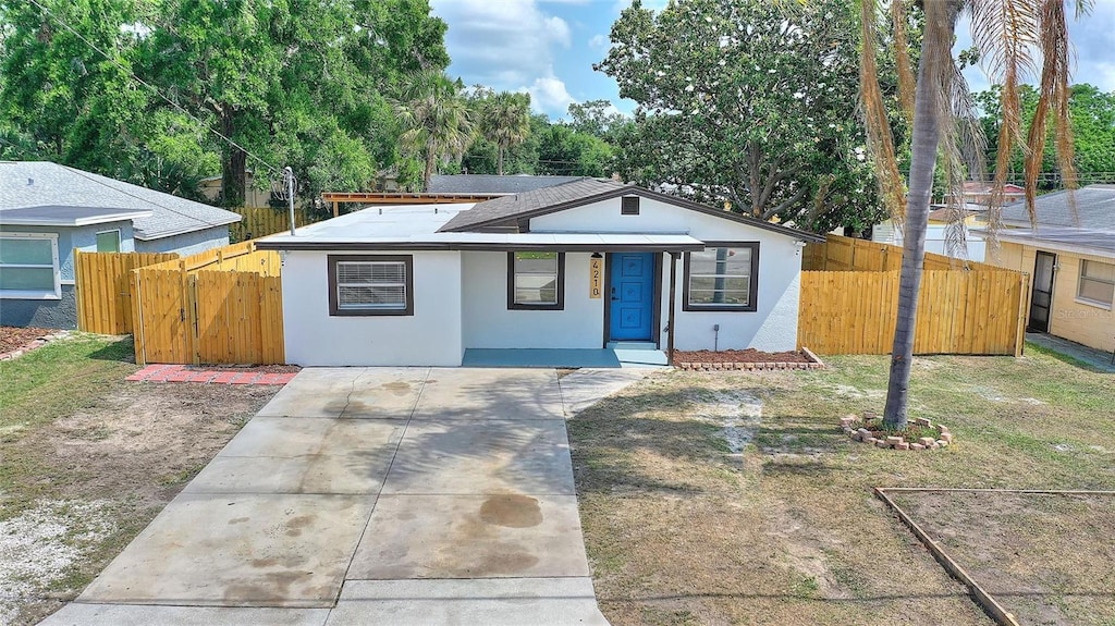 4210 E Grove St, Tampa, FL 33610 - bungalow-style house featuring stucco siding, concrete driveway, fence, and a gate