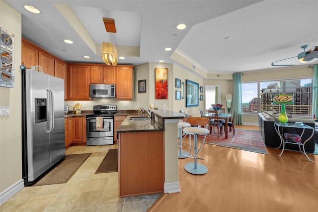 449 S 12th St Unit 2205, Tampa, FL 33602 - kitchen featuring appliances with stainless steel finishes, a sink, a peninsula, a breakfast bar area, and recessed lighting
