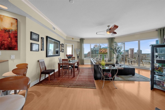 449 S 12th St Unit 2205, Tampa, FL 33602 - dining space featuring wood finished floors, a ceiling fan, crown molding, a view of city, and baseboards