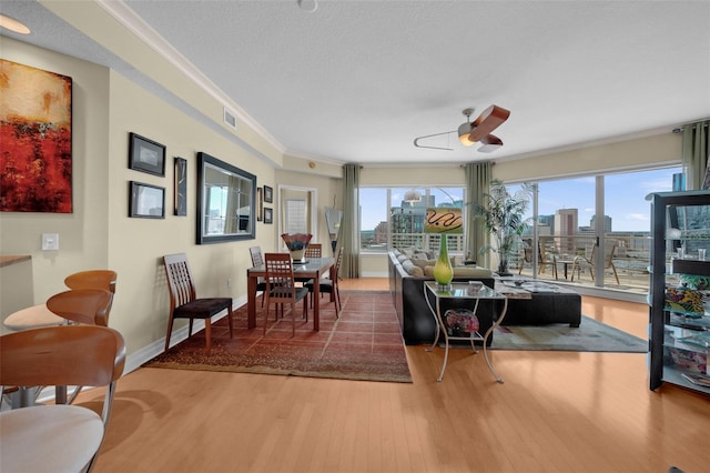 449 S 12th St Unit 2205, Tampa, FL 33602 - dining area with wood finished floors, a ceiling fan, ornamental molding, baseboards, and a city view
