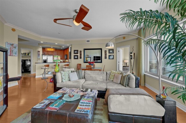 449 S 12th St Unit 2205, Tampa, FL 33602 - living area featuring crown molding, ceiling fan, baseboards, and light wood-style floors