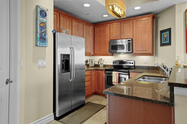449 S 12th St Unit 2205, Tampa, FL 33602 - kitchen featuring stainless steel appliances, a sink, dark stone countertops, a peninsula, and recessed lighting