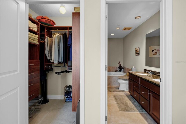 449 S 12th St Unit 2205, Tampa, FL 33602 - bathroom with a spacious closet, vanity, a bath, recessed lighting, and baseboards