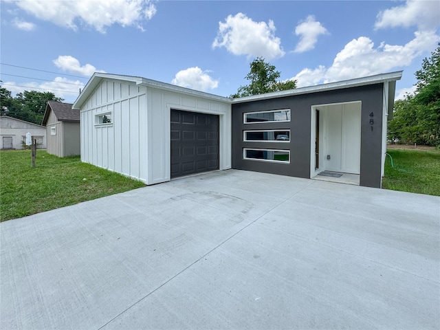garage featuring concrete driveway
