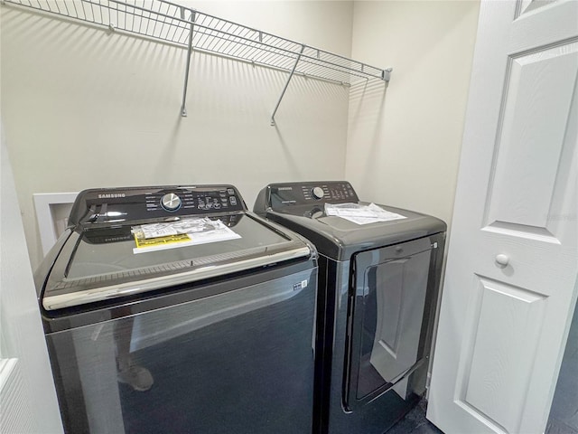 clothes washing area with independent washer and dryer